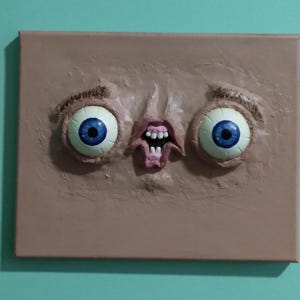 Shock & Awe face sculpture wall art