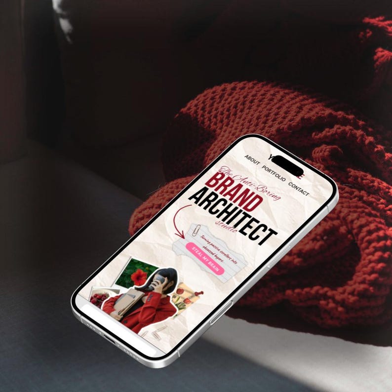May include: A smartphone displays a website for "The Anti-Boring Brand Architect Studio." The screen features the words "BRAND ARCHITECT" in large red letters. A collage of images and text is also visible on the screen.