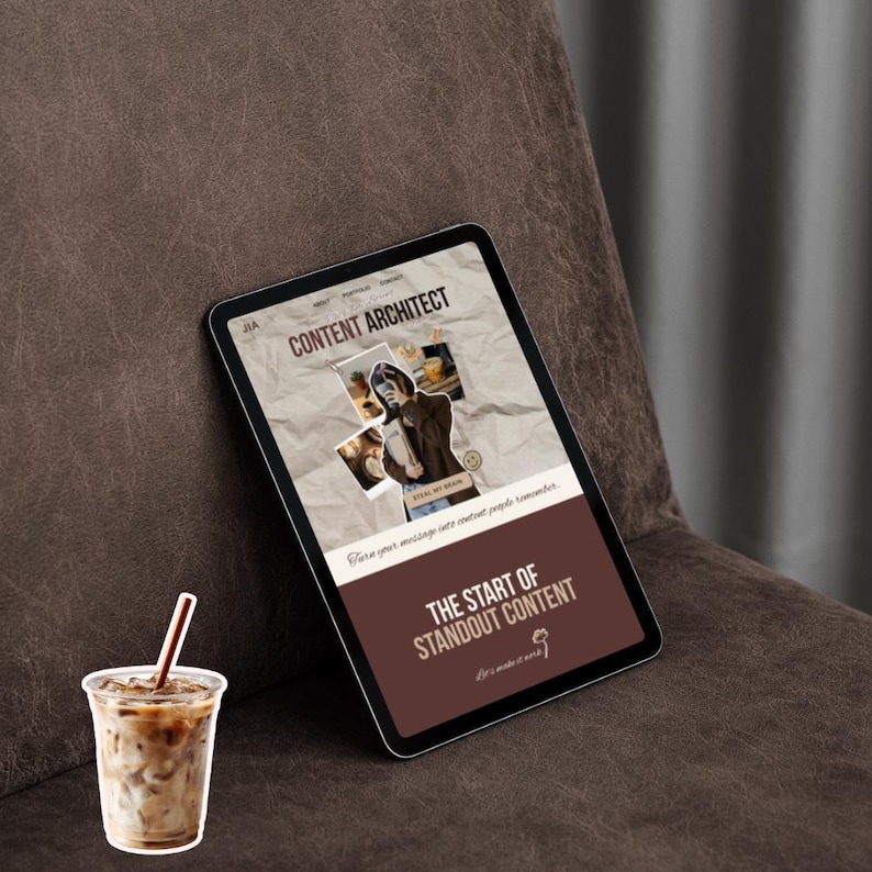 May include: A digital tablet displaying a website titled "CONTENT ARCHITECT" with the text "THE START OF STANDOUT CONTENT." A clear plastic cup with iced coffee and a straw sits in front of the tablet. The tablet rests on a brown leather surface.