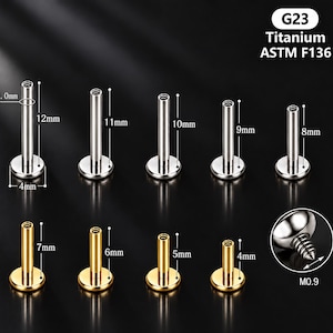 Könnte beinhalten: Eine Sammlung von G23 Titan ASTM F136 Labret-Steckern in Silber- und Goldtönen. Die silbernen Stecker sind 8mm bis 12mm lang, die goldenen 4mm bis 7mm. Jeder Stecker hat eine 4mm Basis, 1.0mm Stärke und ein M0.9 Gewinde für den Aufsatz.