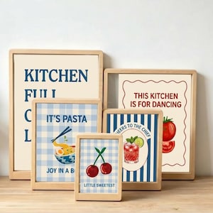 May include: A collection of five rectangular wall art prints in light wood frames. The prints feature various kitchen-themed illustrations and text including KITCHEN FULL, IT'S PASTA JOY IN A BOWL, THIS KITCHEN IS FOR DANCING, LITTLE SWEETEST with cherries, and CHEERS TO THE CHIEF with a cocktail.