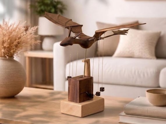 A rechargeable, silently whirring wooden dragon automaton — genuine mechanical artistry you'd stop and stare at on any desk.