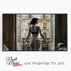 May include: Black and white framed art print featuring a woman in lingerie standing on a balcony, looking out at a European cityscape. The print includes the text "Nyah Mari After Dark" and "4K Frame TV Art".