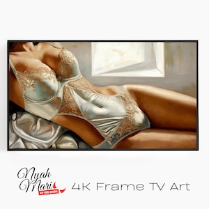 May include: A framed artwork featuring a figure in light blue lingerie with gold lace detailing. The painting depicts a reclining pose, with soft lighting and a neutral background. The text "Nyah Mari" and "4K Frame TV Art" are visible.