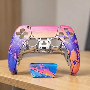 May include: A replacement shell for a video game controller featuring a vibrant sunset gradient of pink, orange, and purple with black palm tree silhouettes. A separate matching touchpad cover displays the letters VI in a bold, stylized font.