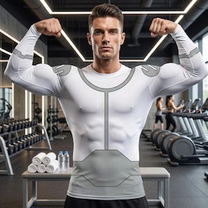 May include: White long-sleeve compression shirt with gray accents. The shirt features a design that outlines the chest and shoulders. The model is flexing in a gym setting, showcasing the shirt's fit and design. The shirt is designed for athletic activities.