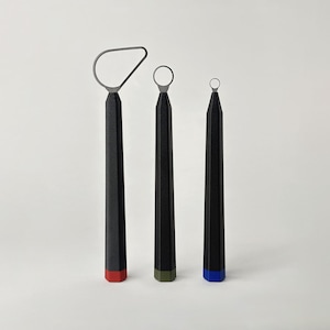 May include: Three pottery trimming tools with black hexagonal handles and metal wire loops at the top. Each tool features a different colored base: red, olive green, and blue. The wire loops vary in shape and size, including a large pear shape.
