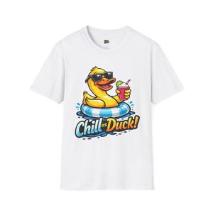 May include: White t-shirt featuring a cartoon duck wearing sunglasses and floating on a blue and white striped inner tube. The duck is holding a pink drink with a lime and the text "Chill as Duck!" is below the duck.
