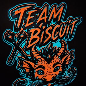 May include: A graphic print on a black background featuring the text TEAM BISCUIT in orange with a bright blue outline. To the left are two crossed whisk-like tools. Below the text is a stylized orange dragon head with a large, dark mustache.