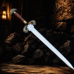 May include: A double-edged sword with a polished silver-toned blade, a dark brown wooden grip, and an ornate metallic crossguard featuring intricate scrollwork. The pommel is rounded with engraved patterns and a metallic finish at the top.