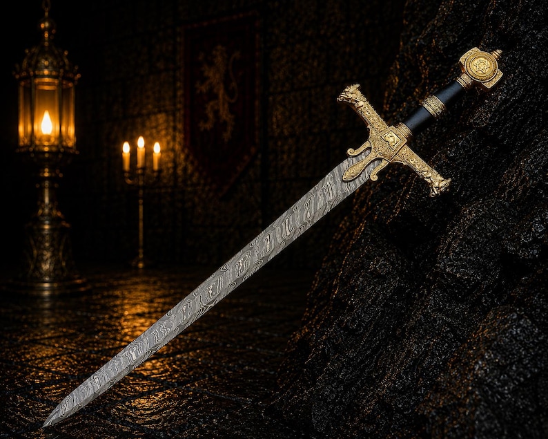 May include: A sword with a patterned Damascus steel blade, a gold-coloured metal crossguard featuring intricate relief carvings, and a black grip. The pommel is a gold-coloured metal disc with a central star emblem and decorative detailing.