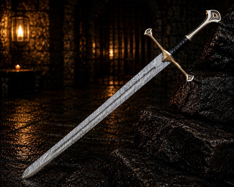 May include: A double-edged sword featuring a patterned Damascus steel blade with a visible wavy grain. The hilt includes a gold-toned crossguard, a black leather-wrapped grip, and a metallic pommel with a triangular cutout detail.