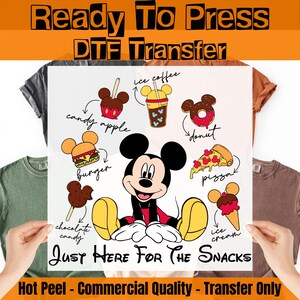 May include: A Ready To Press DTF Transfer sheet featuring a central Mickey Mouse illustration surrounded by various snacks including a candy apple, ice coffee, donut, burger, pizza, chocolate candy, and ice cream, with the text Just Here For The Snacks.