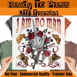 May include: A DTF transfer sheet featuring the text I AM NO MAN in a gothic font above a silver spiked helmet pierced by a sword. The design includes red roses, green leaves, and four brown butterflies with intricate wing patterns on a white background.