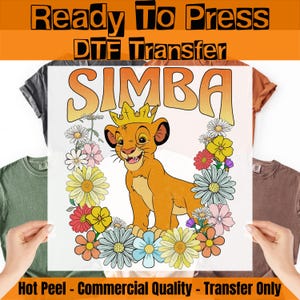 May include: DTF transfer featuring Simba the lion cub wearing a crown, surrounded by colorful flowers. The word "SIMBA" is in orange letters. The text "Ready To Press" and "Hot Peel - Commercial Quality - Transfer Only" are also visible.