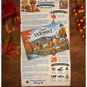 May include: A printed newsletter titled Maisy's Travel Society Vermont State Edition featuring a cartoon dog, text, and state symbols, layered with a postcard depicting a scenic Stowe Vermont landscape with autumn foliage and a church steeple.
