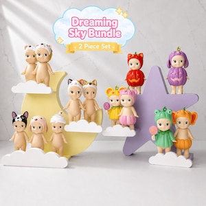 May include: A selection of small, quirky figurines, each with distinctive costumes and accessories. The figurines are arranged on cloud-shaped platforms and a star-shaped stand. The image includes the text "Dreaming Sky Bundle" and "2 Piece Set".
