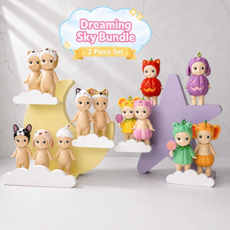 May include: A selection of small, quirky figurines, each with distinctive costumes and accessories. The figurines are arranged on cloud-shaped platforms and a star-shaped stand. The image includes the text "Dreaming Sky Bundle" and "2 Piece Set".