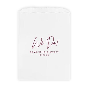 May include: White favor bag with a burgundy script font that reads "We Do!" with the names Samantha & Wyatt and the date 04.16.25.