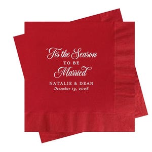 May include: Red paper napkins with white text that reads "'Tis the Season to be Married" with the names Natalie & Dean and the date December 19, 2026.