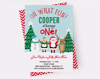 May include: A Christmas-themed invitation for a first birthday party. The invitation features a snowman, elf, Santa Claus, and a reindeer standing in front of a snowy background with Christmas trees. The text on the invitation reads "Oh What Fun! Cooper is turning One!" and includes details about the party, such as the date, time, and location.
