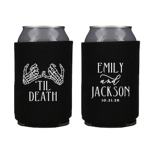 May include: Two black and white wedding themed can coolers. One cooler features a skeleton hand design with the text 'Til Death'. The other cooler features the text 'Emily and Jackson 10.31.26'.