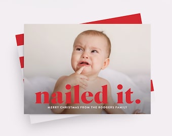 May include: A Christmas card featuring a photo of a baby with a funny expression. The text on the card reads "nailed it." and "Merry Christmas from the Rodgers Family."