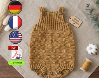 May include: A mustard yellow knitted romper featuring a textured bobble pattern, ribbed straps with two buttons at the top, and three buttons at the bottom. A wooden tag attached to the garment is inscribed with the text Kindly Knitwear.