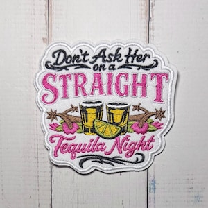 May include: An embroidered patch featuring the black text Don't Ask Her on a, the pink text STRAIGHT, two yellow shot glasses with a green lime wedge, and the pink text Tequila Night with black decorative flourishes on a white background.