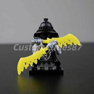 May include: A black minifigure with a black hat and yellow dual swords. The figure has silver accents and a chain. The text "Customs87" is visible on the left side of the image.
