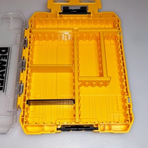 May include: Bright yellow tool organizer with multiple compartments and a clear lid. The organizer has a handle and black hinges. The clear lid has the word "DEWALT" printed on it.