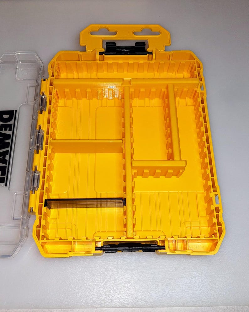 May include: Bright yellow tool organizer with multiple compartments and a clear lid. The organizer has a handle and black hinges. The clear lid has the word "DEWALT" printed on it.
