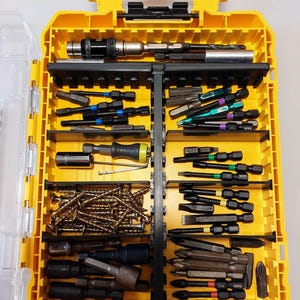 May include: A yellow toolbox filled with various screwdriver bits, sockets, and screws. The case is divided into compartments, offering organized storage for different tools. The tools are in various colors, including black, silver, and green.