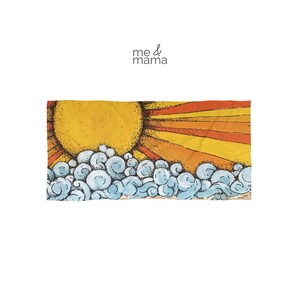 May include: A rectangular beach towel featuring a graphic illustration of a large yellow sun with orange rays rising above stylized light blue ocean waves. The text me & mama is printed in black above the illustration on a white background.