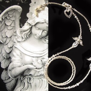 May include: A silver eyeglass chain with clear crystal beads and angel charms. The chain is double-stranded and has a heart charm at the top.