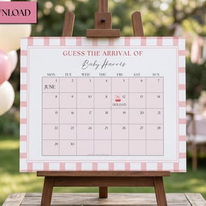 May include: A baby shower calendar on a wooden easel, with a pink and white gingham border. The calendar reads "Guess the Arrival of Baby Harris" and includes the month of June. Pink balloons and flowers are in the background.