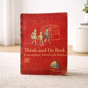 May include: Vintage red "Think-and-Do Book" with illustrations of children and a bus. The book cover features the text "Think-and-Do Book. to accompany: Streets and Roads." and "Cathedral Basic Readers: 3".