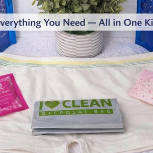 May include: An all-in-one kit with feminine hygiene products. The kit includes feminine wipes, a disposal bag, and a panty liner. The text "Everything You Need - All in One Kit" is displayed on the image.
