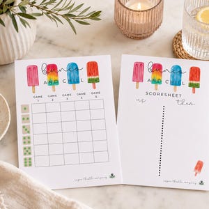 May include: Two white game sheets with colorful popsicle illustrations and the text "bunch and chill". One sheet has a grid and dice graphics, the other a score sheet. A gold pen, dice, and a glass of water are also visible.