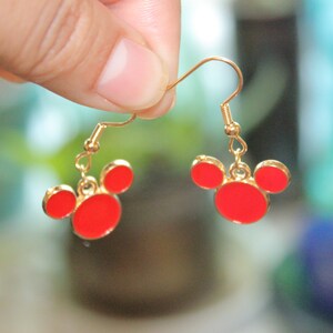 May include: Gold earrings with red Mickey Mouse head charms.