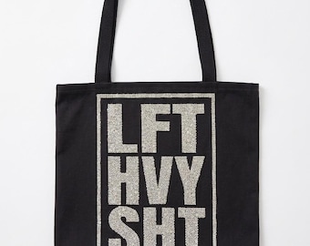 Prydnadsfull lyxig tygväska med "LFT HVY SHT"-motiv