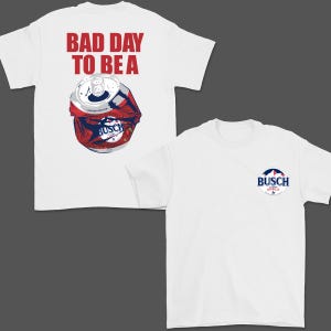 May include: White t-shirt with a graphic of a crushed Busch Light beer can and the text "BAD DAY TO BE A" in red. The shirt also features a small Busch Light logo on the front.
