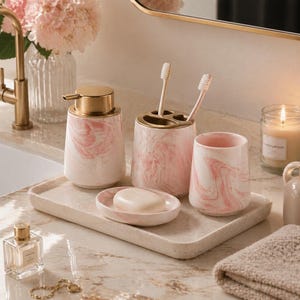 May include: A pink and white marble effect bathroom set. The set includes a soap dispenser with a gold pump, a toothbrush holder, a tumbler, and a soap dish with a bar of soap. The items are arranged on a rectangular tray, ideal for a bathroom.