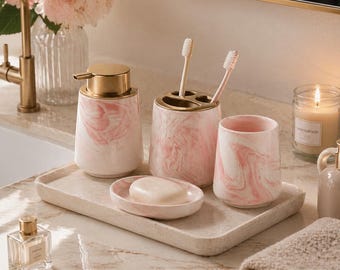 Juego de baño de cerámica con efecto mármol rosa, accesorios de tocador modernos, decoración minimalista.