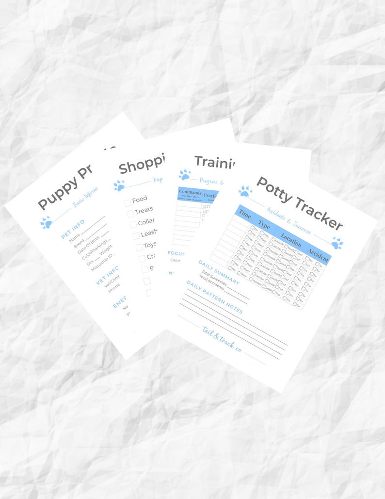May include: A stack of four white paper sheets with blue text and paw print icons. The sheets include "Puppy Info", "Shopping", "Training", and "Potty Tracker" forms. The forms are designed to track a puppy's information and progress.