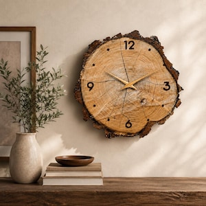 May include: A wall clock crafted from a natural wood slice featuring a live edge, visible wood grain, and dark bark. The clock face displays black numerals at the 12, 3, 6, and 9 positions, with simple dots for other hours and thin gold-colored hands.