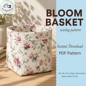 Może przedstawiać: Tkaninowy kosz z kwiatowym wzorem różowych róż i zielonych liści na kremowym tle. Widoczny jest tekst "BLOOM BASKET sewing pattern". Wzór dostępny jako natychmiastowe pobranie PDF.