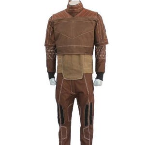 May include: Brown costume with white stitching details. The outfit includes a high-collared jacket with shoulder accents, a wide belt, and matching pants. Black accents are on the pants. The costume is displayed on a mannequin.