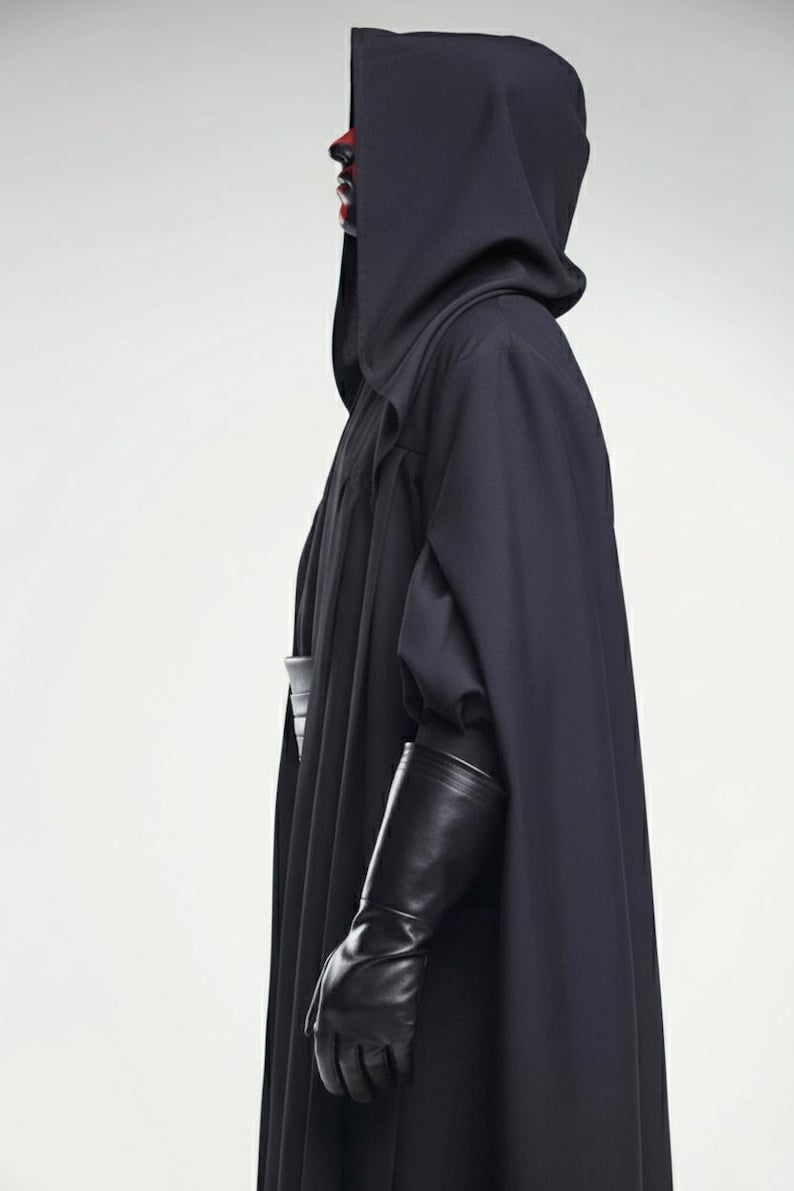 May include: A dark navy hooded cloak with long sleeves and black leather gloves. The person's face is painted red and black. The costume is likely for cosplay or a themed event.