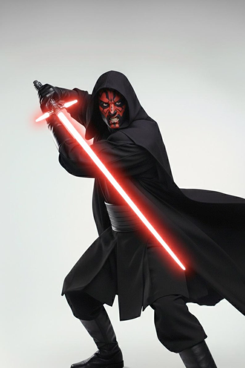May include: A figure in a black hooded cloak and trousers, holding a red double-bladed lightsaber. The character has red and black facial markings and black gloves. The lightsaber is glowing red.